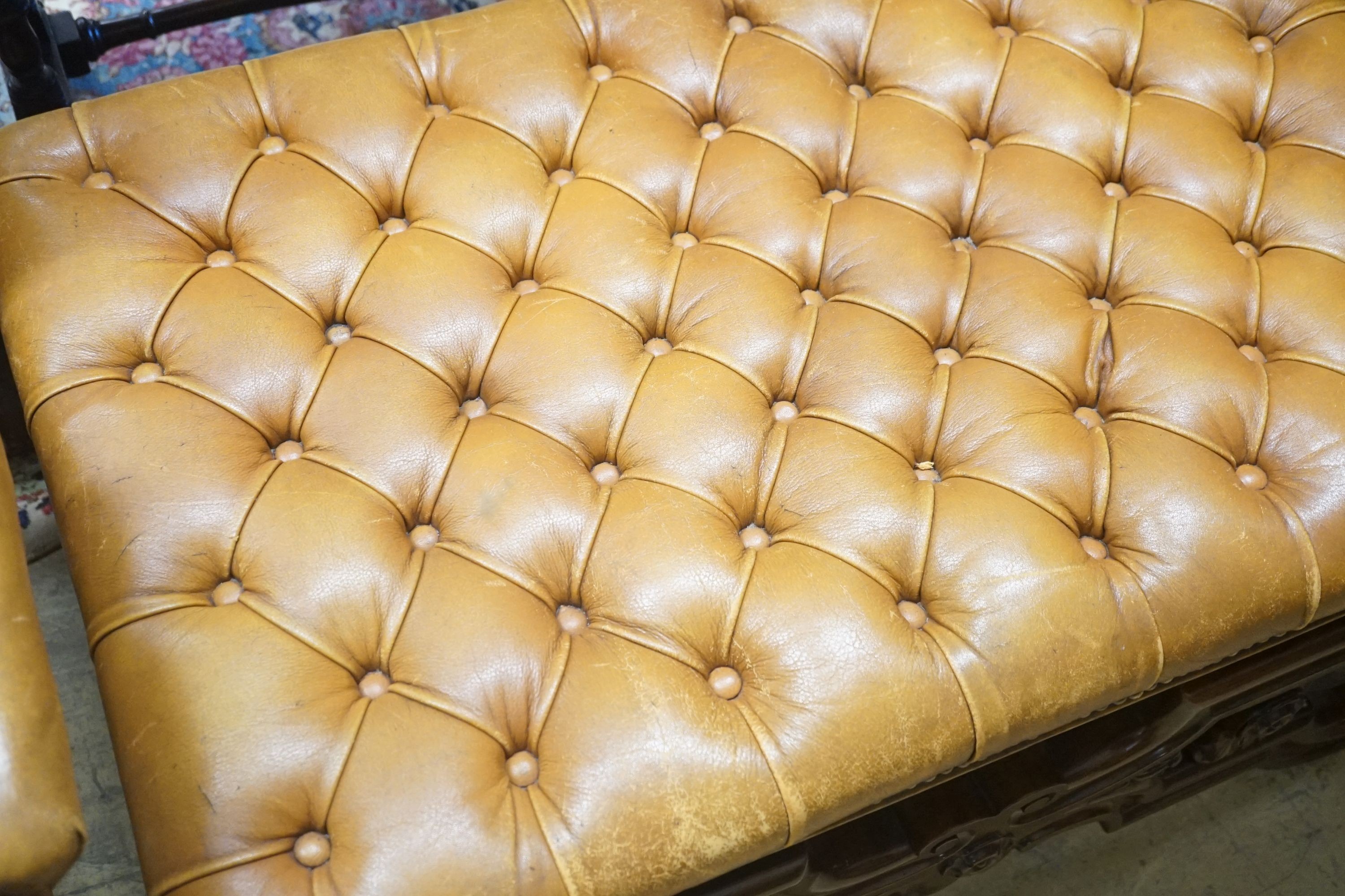 A Victorian carved X-framed rosewood footstool, upholstered in a buttoned brown leather, width 90cm depth 57cm height 42cm